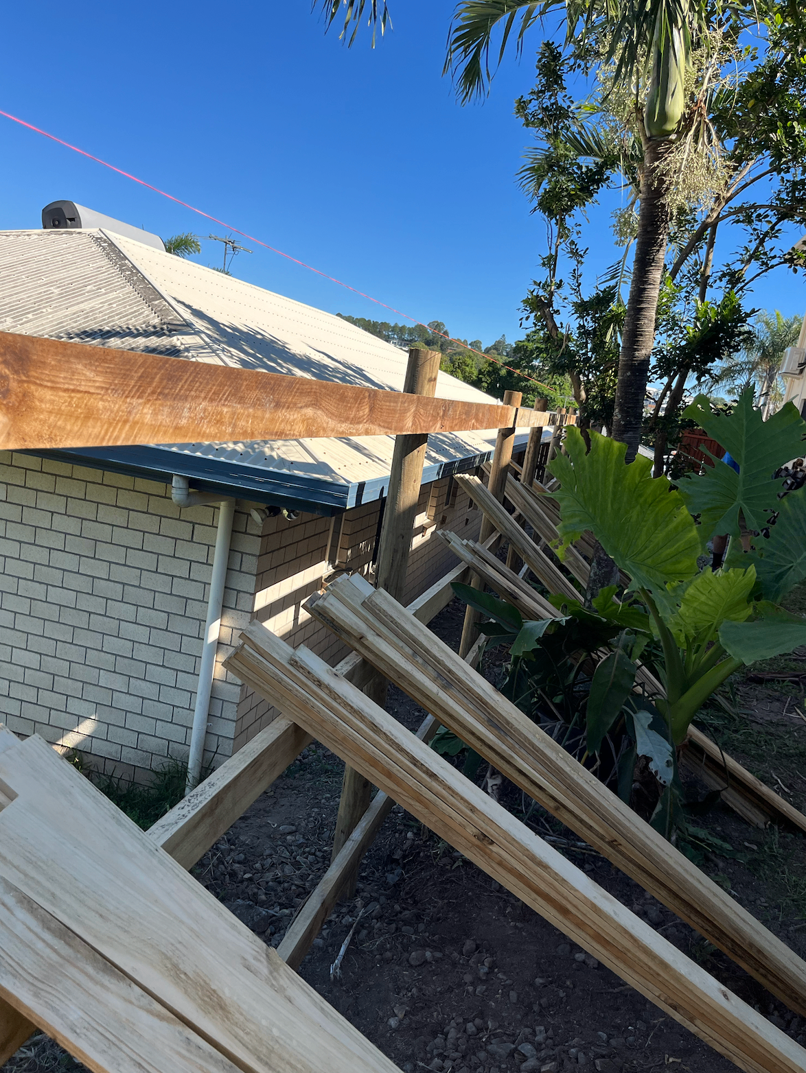 Timber fence posts and rails levelled to a string line before palings go on