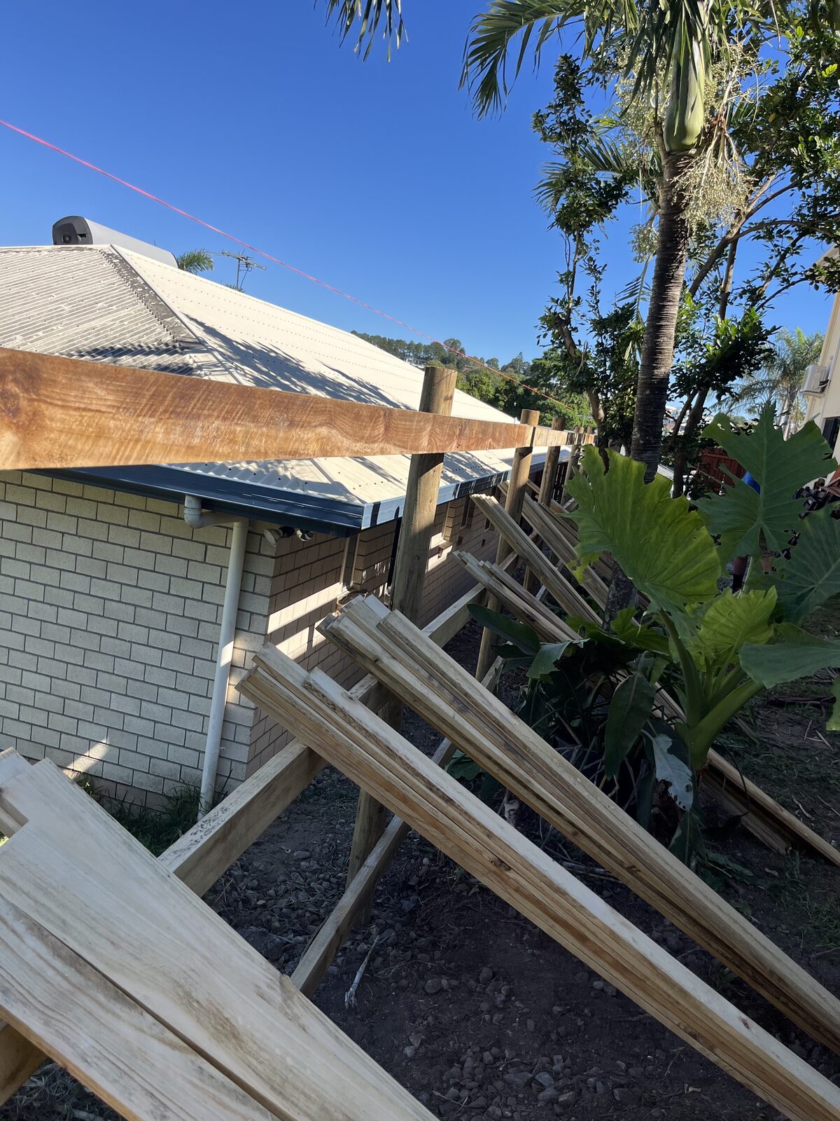 Timber fence posts and rails set up during a fence build in Mackay