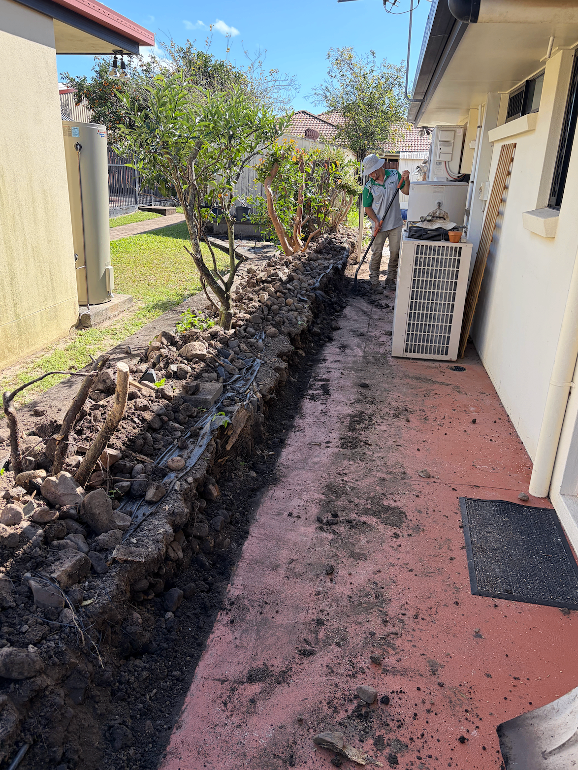 Old rock garden bed stripped out along the side of a Mackay house