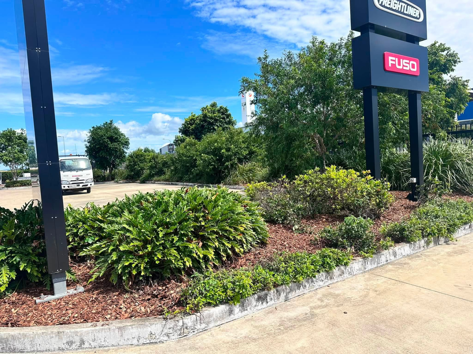 Maintained garden beds and hedges at a Mackay commercial dealership